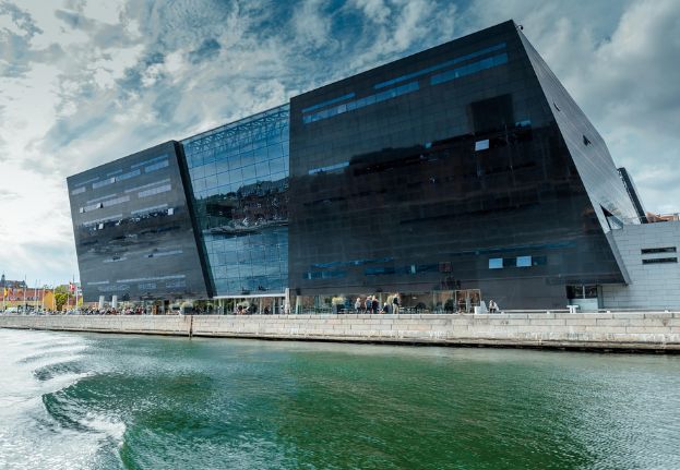 The Black Diamond in Copenhagen seen from the water with its modern black glass facade along the harbor